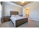 Comfortable bedroom featuring a dark wood bed frame and neutral tones, and an attached bathroom at 5814 Bimini Twist Loop, Orlando, FL 32819