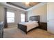 Inviting bedroom featuring a dark wood bed frame and neutral tones, complemented by soft carpeting at 5814 Bimini Twist Loop, Orlando, FL 32819