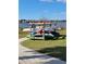 Community boat storage area with various colorful boats and a lake view backdrop at 5814 Bimini Twist Loop, Orlando, FL 32819