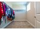 Walk-in closet providing ample storage with hanging racks and shelving, illuminated by a window at 5814 Bimini Twist Loop, Orlando, FL 32819