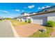 Row of townhome garages with neat brick driveways and manicured shrubbery at 5814 Bimini Twist Loop, Orlando, FL 32819