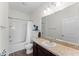 Well-lit bathroom with a shower-tub combo, dark wood cabinets, and a large mirror at 5841 Bullock Pl, St Cloud, FL 34771