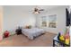 Cozy bedroom with carpeted floors, a ceiling fan, and two windows at 5841 Bullock Pl, St Cloud, FL 34771