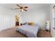 Bright bedroom with a ceiling fan and a view into the connected bathroom at 5841 Bullock Pl, St Cloud, FL 34771