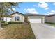 Charming single-story home with a well-manicured lawn and a two-car garage in a suburban neighborhood at 5841 Bullock Pl, St Cloud, FL 34771