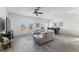 A modern living room is bathed in natural light and complemented by wood-look floors and comfortable seating at 5841 Bullock Pl, St Cloud, FL 34771