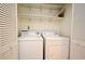 Bright laundry area equipped with a washer and dryer, featuring shelving for organization at 609 Gallery Dr # 2, Winter Park, FL 32792