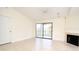 Living area showcasing tile floors, a fireplace, and sliding glass doors leading to an outdoor balcony at 609 Gallery Dr # 2, Winter Park, FL 32792