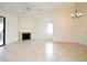 Spacious living room with tile floors, fireplace, and view into the dining area and balcony at 609 Gallery Dr # 2, Winter Park, FL 32792