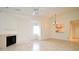 Open living room features tile floors, a fireplace, and a passthrough to the kitchen at 609 Gallery Dr # 2, Winter Park, FL 32792