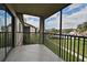 Balcony view overlooking pool and landscaping with a tiled floor and black metal railing for outdoor enjoyment at 609 Gallery Dr # 2, Winter Park, FL 32792