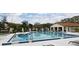 Community pool featuring a zero entry side and a six feet deep side and a small clubhouse at 609 Gallery Dr # 2, Winter Park, FL 32792