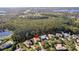 Scenic aerial perspective displaying the home's setting near a sprawling forest and community features at 6424 Cartmel Ln, Windermere, FL 34786