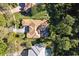 Stunning aerial view showcasing the home's unique architecture, screened-in pool, and beautifully landscaped surroundings at 6424 Cartmel Ln, Windermere, FL 34786