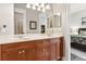 This bathroom features wood cabinets, double sinks, and an adjoining bedroom doorway at 6424 Cartmel Ln, Windermere, FL 34786