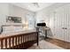 Cozy bedroom featuring wood floors, a ceiling fan, and a desk for a comfortable workspace at 6424 Cartmel Ln, Windermere, FL 34786