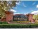 A brick entrance sign welcomes you to Lake Butler Sound with colorful flowers and lush greenery at 6424 Cartmel Ln, Windermere, FL 34786