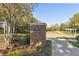 An ornate community entrance with brick features, attractive landscaping, a fountain, and a walking path at 6424 Cartmel Ln, Windermere, FL 34786