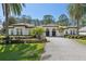 Beautiful home showcasing lush landscaping, a paver driveway, and an elegant facade at 6424 Cartmel Ln, Windermere, FL 34786