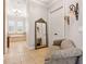 Hallway featuring tile flooring, an ornate mirror, chair and doorway views of the soaking tub at 6424 Cartmel Ln, Windermere, FL 34786