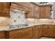 Detailed kitchen with wooden cabinets and tile backsplash at 6424 Cartmel Ln, Windermere, FL 34786