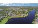 Beautiful aerial of a lakeside community with lush landscaping, walking paths, and stunning water views at 729 Secret Harbor Ln # 105, Lake Mary, FL 32746