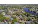 Aerial view of a lakeside community with amenities including tennis courts, pools and plenty of green space at 729 Secret Harbor Ln # 105, Lake Mary, FL 32746