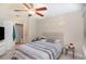 Calm bedroom featuring neutral tones, a ceiling fan and a door to the bathroom at 729 Secret Harbor Ln # 105, Lake Mary, FL 32746