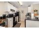 Efficient kitchen layout with white cabinetry, black appliances, and tile flooring at 729 Secret Harbor Ln # 105, Lake Mary, FL 32746