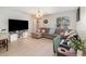 Comfortable living space features tile flooring, neutral paint and a large sectional couch at 729 Secret Harbor Ln # 105, Lake Mary, FL 32746