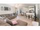 Open-concept living and dining area with tile floors, comfortable seating, and ample natural light at 729 Secret Harbor Ln # 105, Lake Mary, FL 32746
