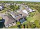 Aerial view of a home with a screened pool in a neighborhood featuring mature trees and landscaping at 753 Daybreak Pl, Longwood, FL 32750