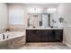 Bright bathroom featuring double vanities, bathtub and neutral color tones at 753 Daybreak Pl, Longwood, FL 32750