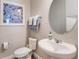 Powder room featuring a modern sink, toilet and mirror at 753 Daybreak Pl, Longwood, FL 32750