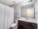 Well-lit bathroom featuring a shower and a dark vanity at 753 Daybreak Pl, Longwood, FL 32750