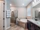 Bright bathroom featuring bathtub and glass enclosed shower with neutral color tones and modern fixtures at 753 Daybreak Pl, Longwood, FL 32750