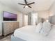 Inviting bedroom displaying a dresser, plush pillows, and a ceiling fan at 753 Daybreak Pl, Longwood, FL 32750