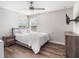 Well-lit bedroom showcases a bed, hardwood floors, and a ceiling fan at 753 Daybreak Pl, Longwood, FL 32750