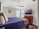 Neutral bedroom features a ceiling fan, tv, and hardwood floors at 753 Daybreak Pl, Longwood, FL 32750