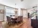 Bright dining room featuring a modern chandelier, neutral colors, and wood floors at 753 Daybreak Pl, Longwood, FL 32750