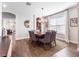 Bright dining room featuring a modern chandelier, neutral colors, and wood floors at 753 Daybreak Pl, Longwood, FL 32750