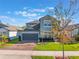 Charming two-story home featuring a well-manicured lawn, brick driveway, and attached two-car garage at 753 Daybreak Pl, Longwood, FL 32750