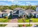 Beautifully landscaped two-story home with stone accents, brick driveway, and great curb appeal at 753 Daybreak Pl, Longwood, FL 32750