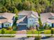 A charming two-story home with stone accents, a well-kept lawn, and a paved driveway at 753 Daybreak Pl, Longwood, FL 32750