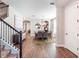 Inviting foyer with wood-look tile flooring, staircase with iron railing, and sight lines into the dining room at 753 Daybreak Pl, Longwood, FL 32750