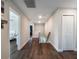 Bright hallway with wood floors leading to bedrooms and stairs with a modern aesthetic at 753 Daybreak Pl, Longwood, FL 32750