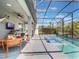 Screened pool with outdoor seating, a grill, ceiling fan and view of the lush green landscape at 753 Daybreak Pl, Longwood, FL 32750