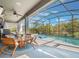 Relaxing screened pool with outdoor seating, ceiling fan, a grill and view of the lush green landscape at 753 Daybreak Pl, Longwood, FL 32750