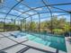 Beautiful screened pool with lounge chairs, a privacy screen, and serene views of the trees at 753 Daybreak Pl, Longwood, FL 32750