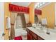 Bathroom with a double sink vanity and a tub with decorative red curtains at 755 Country Charm Cir, Oviedo, FL 32765